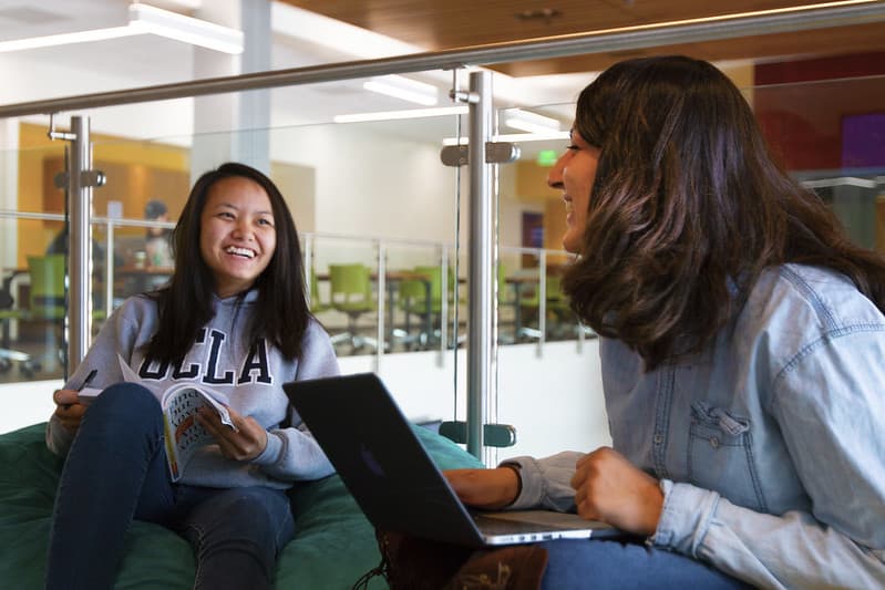 Two students studying and laughing